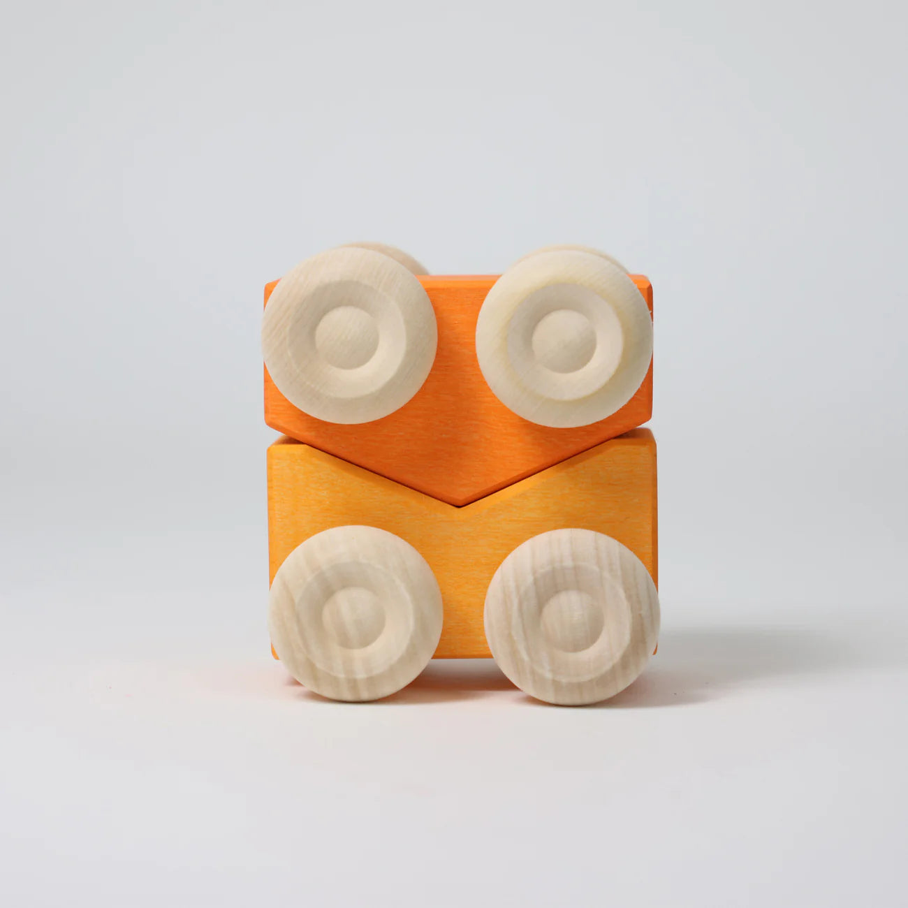 Wooden toy car with orange body and beige wheels on a light gray background