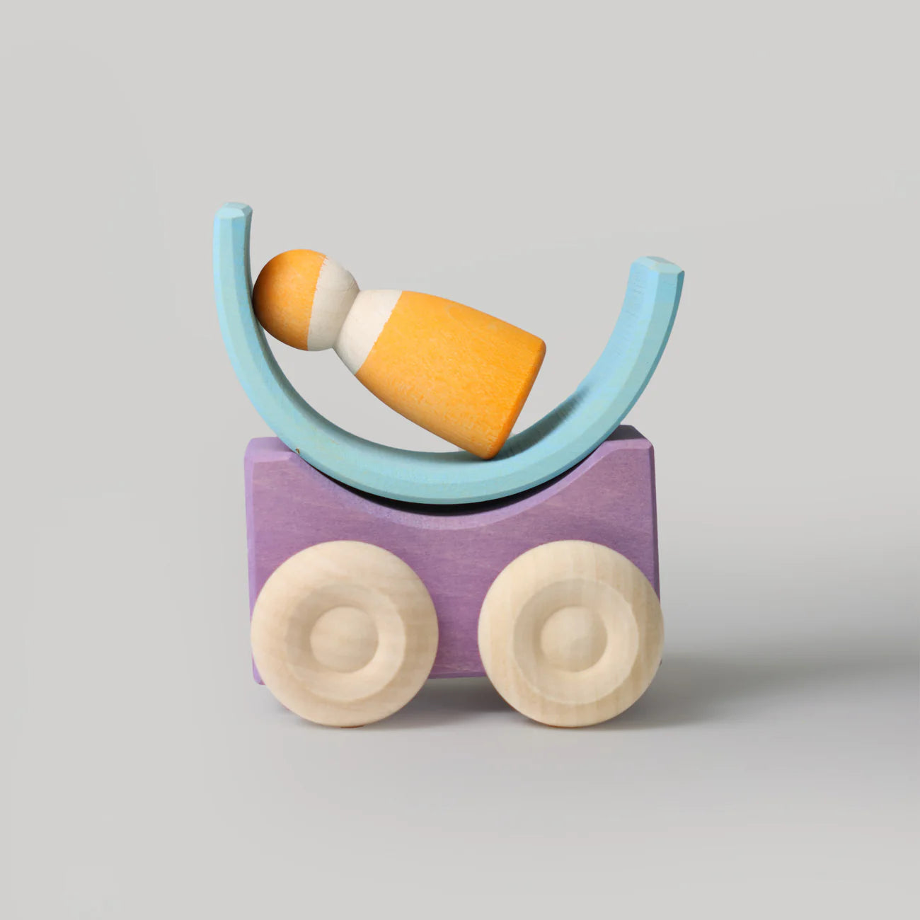 Wooden toy with colorful arch and wheels on a gray background
