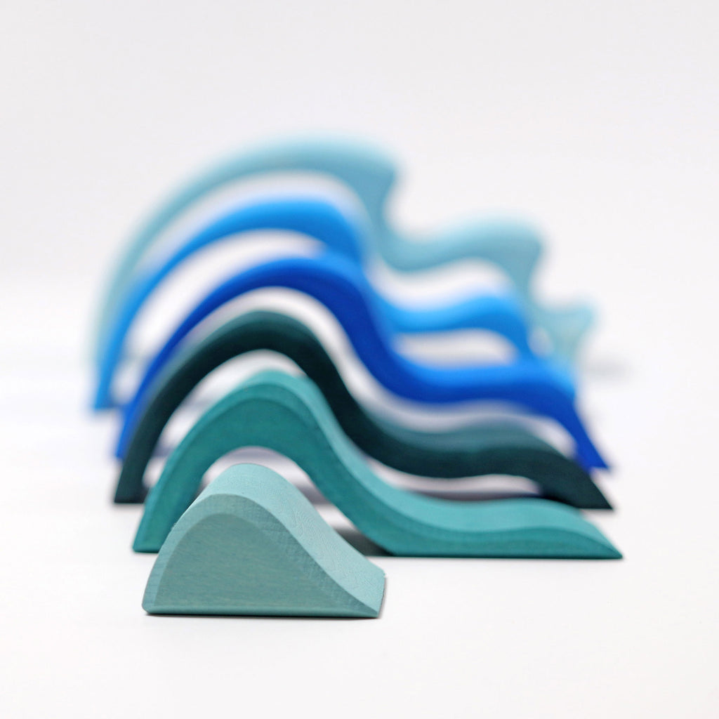 Stack of blue and green foam blocks on a light gray background