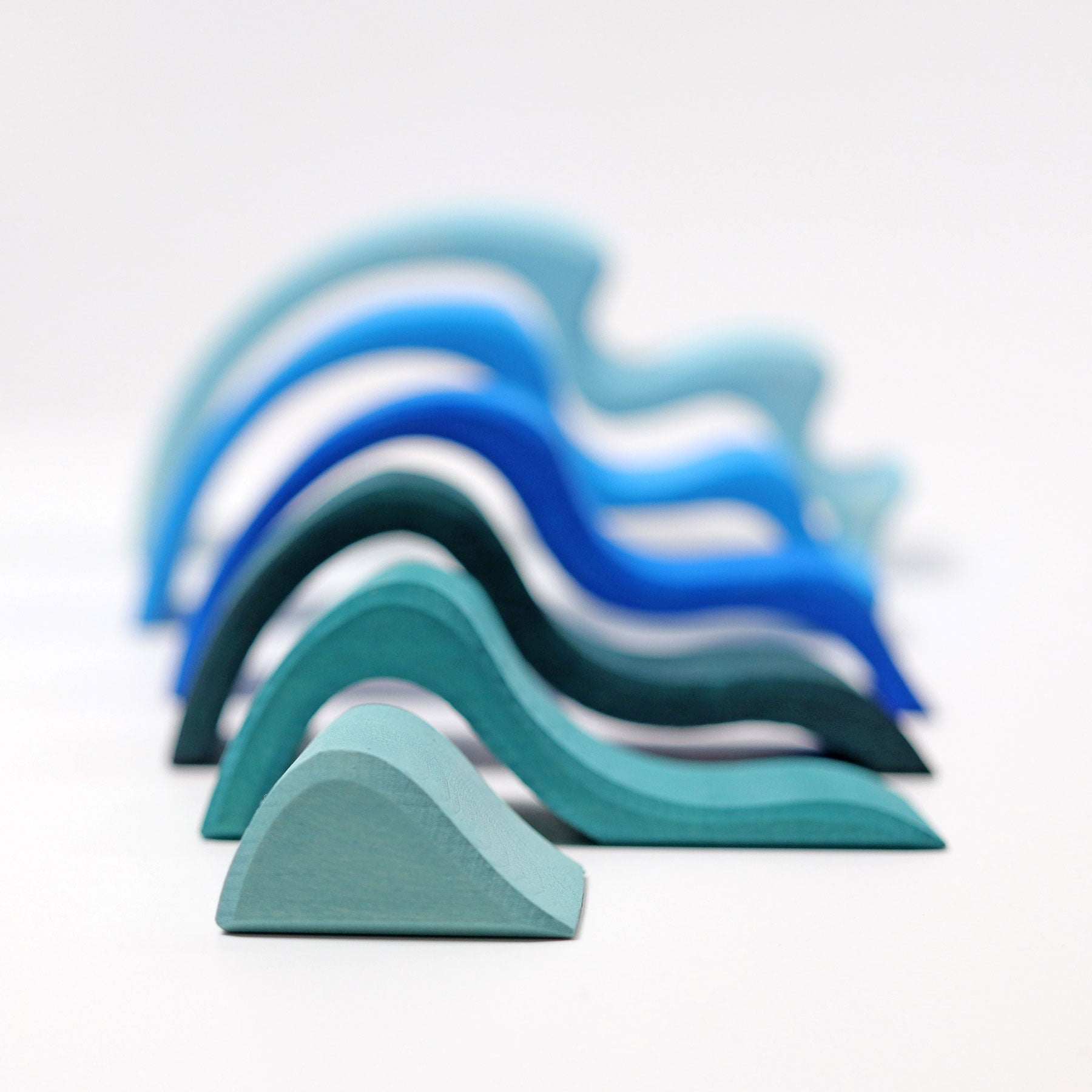 Stack of blue and green foam blocks on a light gray background