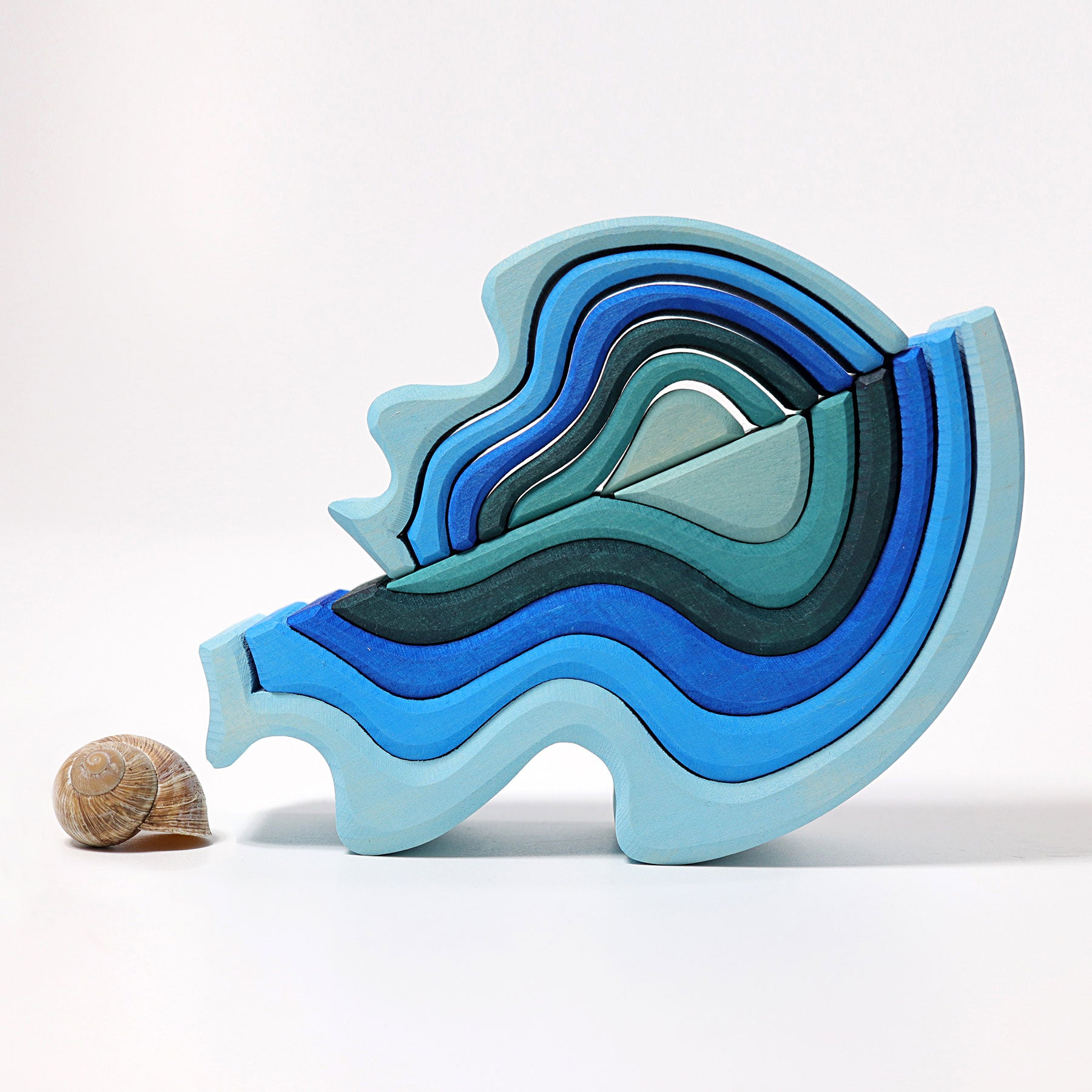 Colorful wooden toy with wavy design on a white background