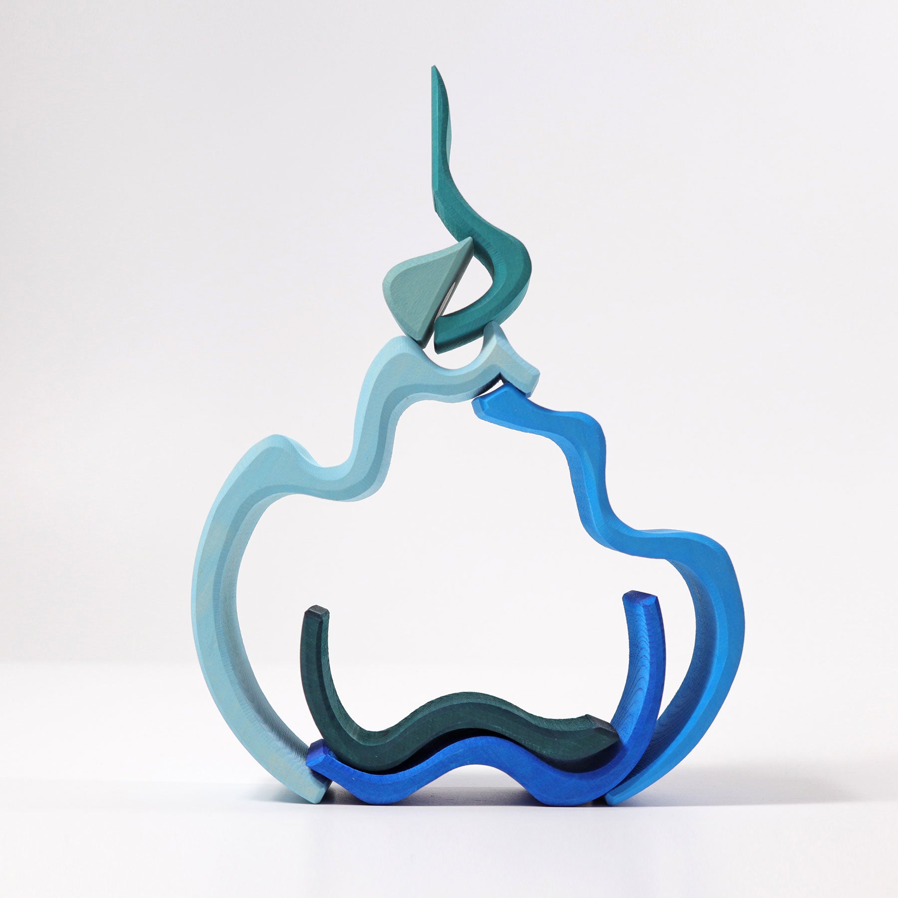 Abstract sculpture in blue, green, and gray on a white background