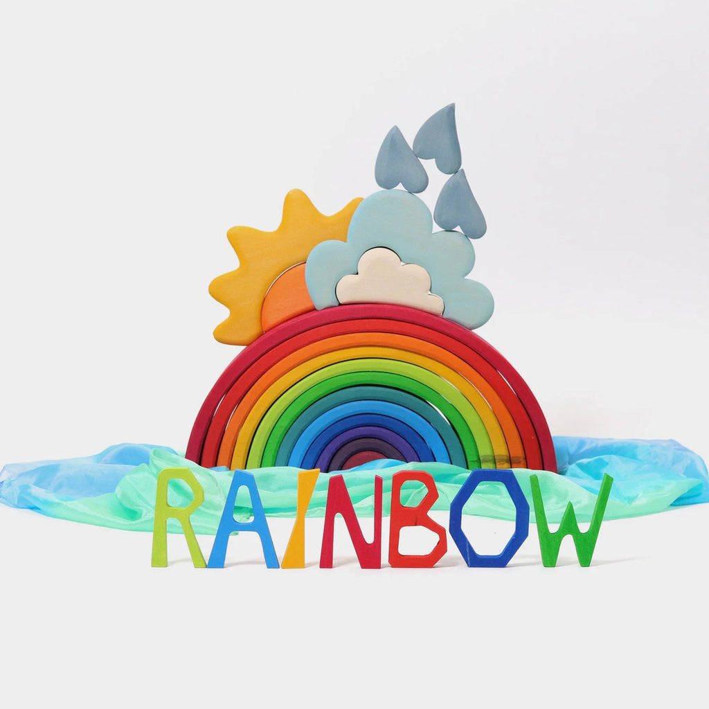 Colorful rainbow toy with sun, clouds, and 'RAINBOW' letters on a light blue background