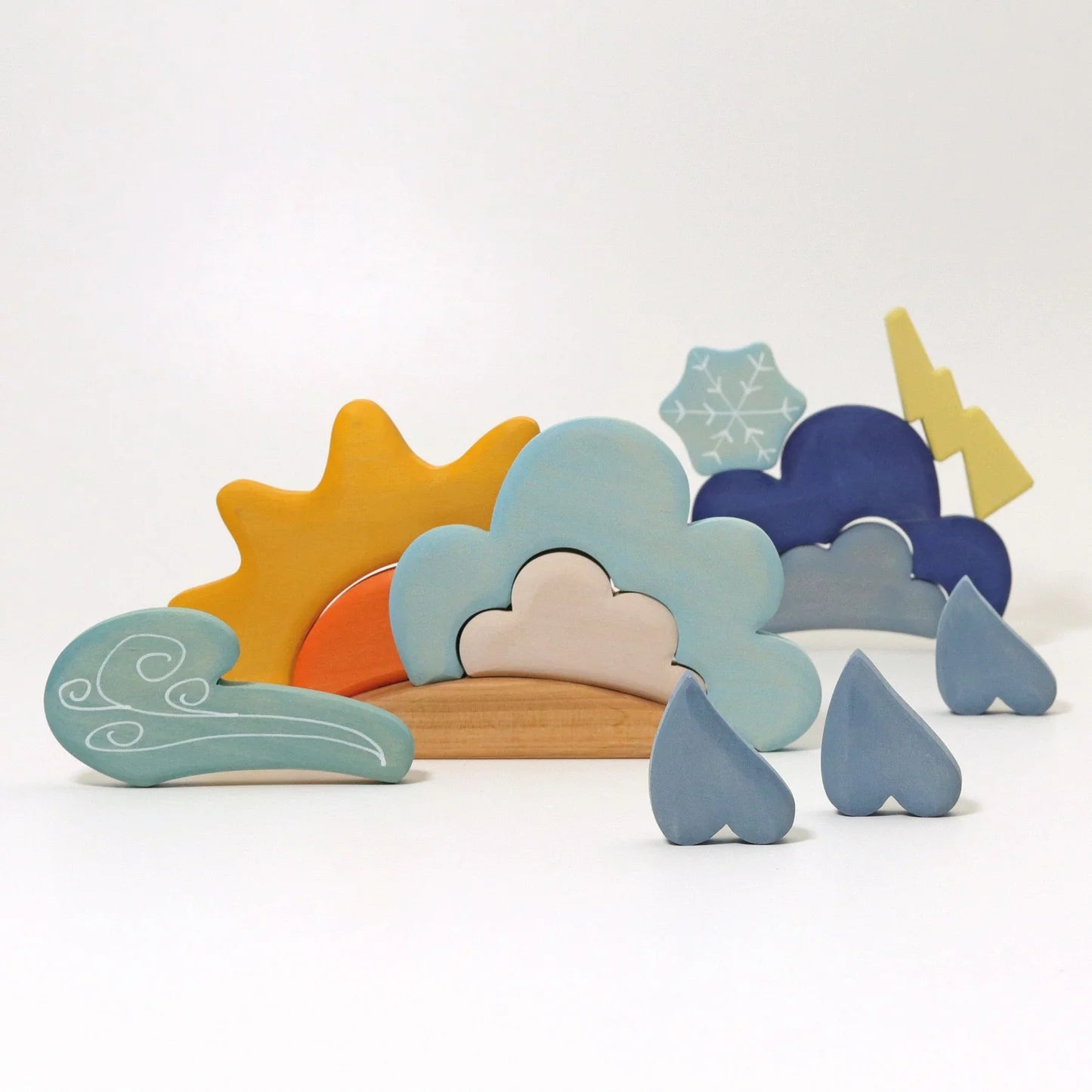 Set of colorful wooden shapes resembling natural elements on a white background