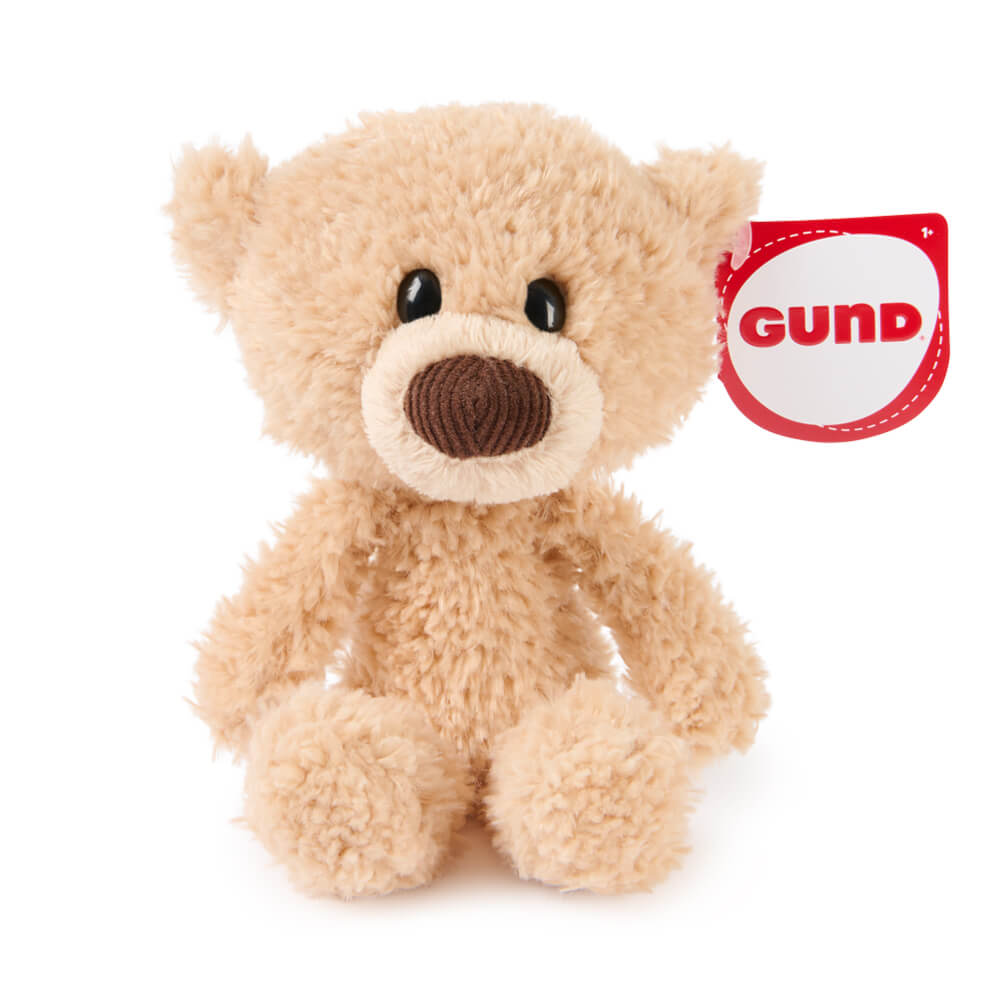 Plush teddy bear with GUND label on a white background