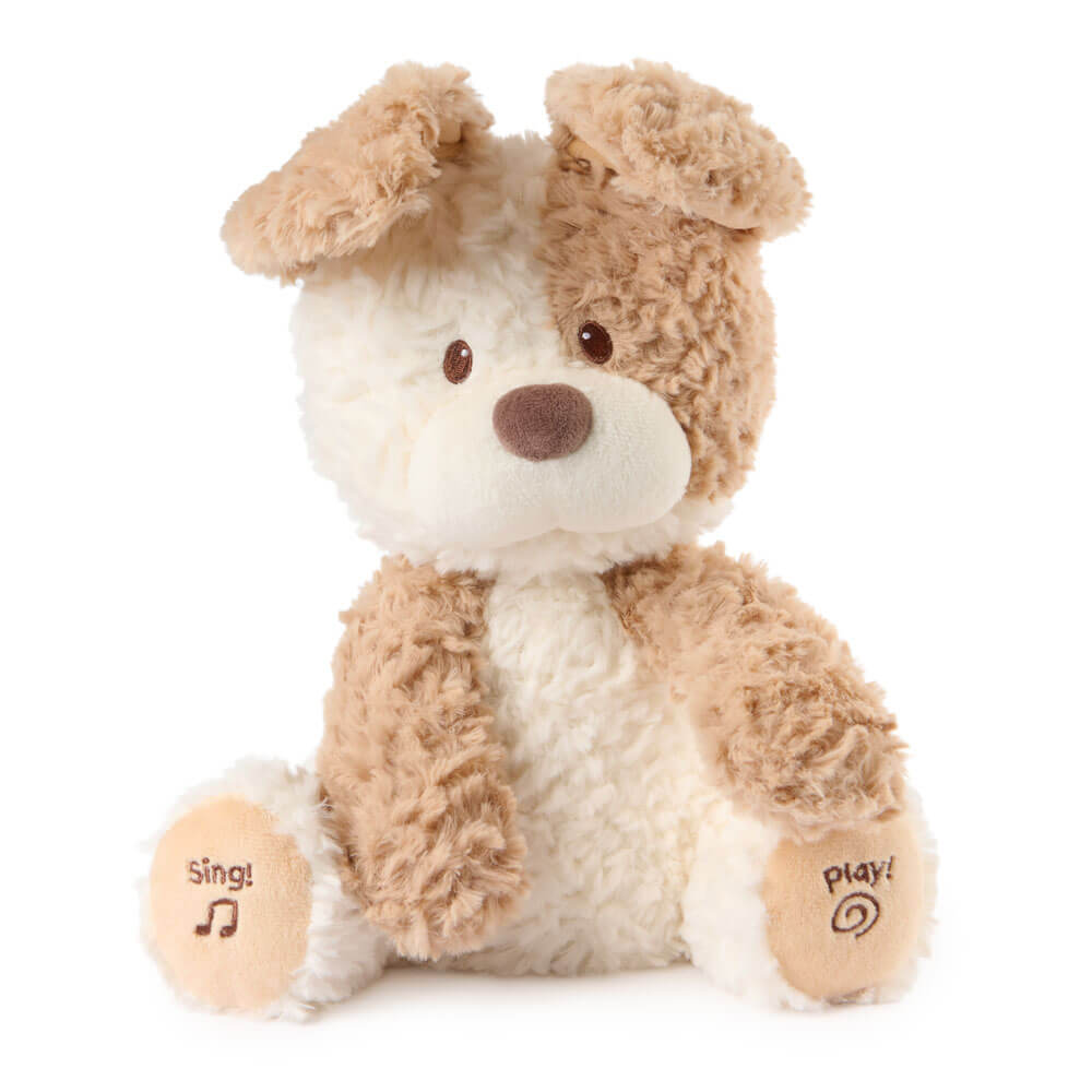 Plush toy dog with beige and white fur on a white background