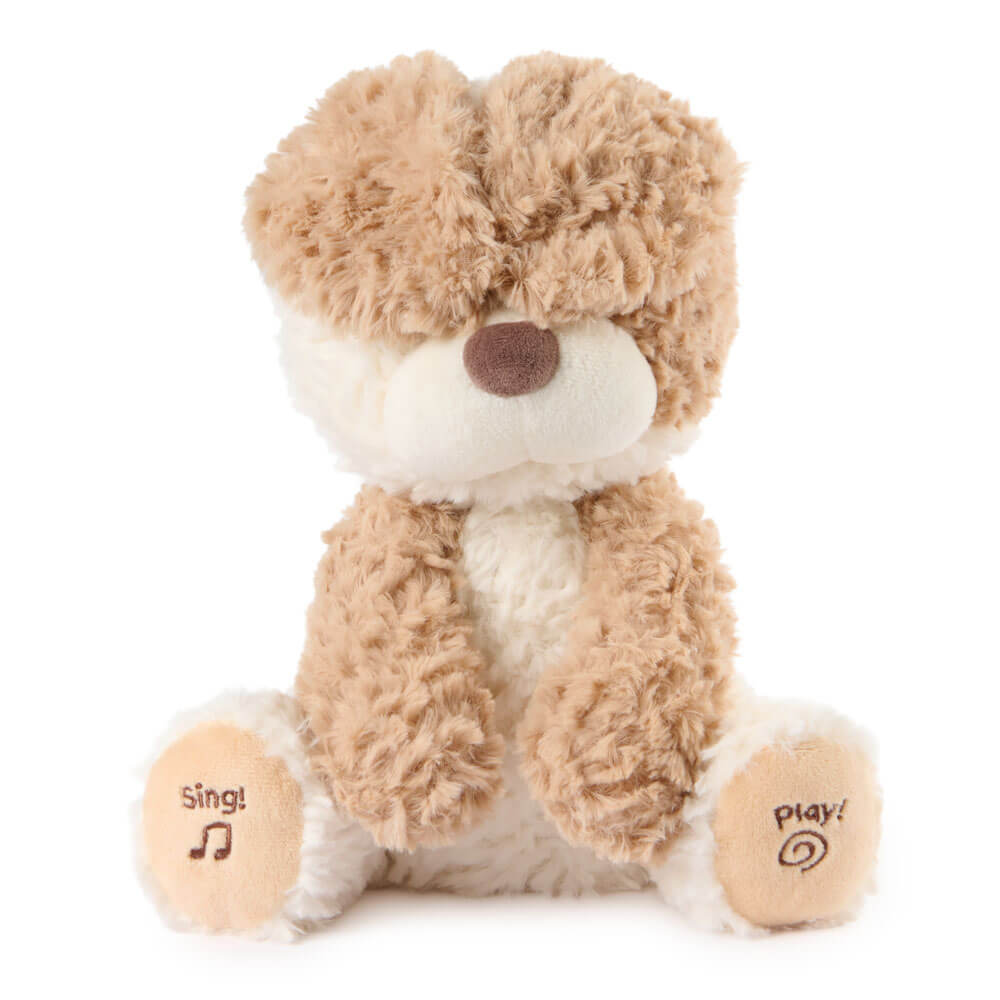 Plush toy dog with 'sing!' and 'play!' buttons on a white background