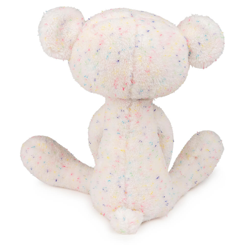 White plush toy with colorful speckles on a white background