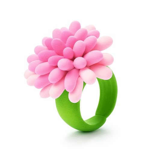 Pink flower-shaped object on a green base against a white background