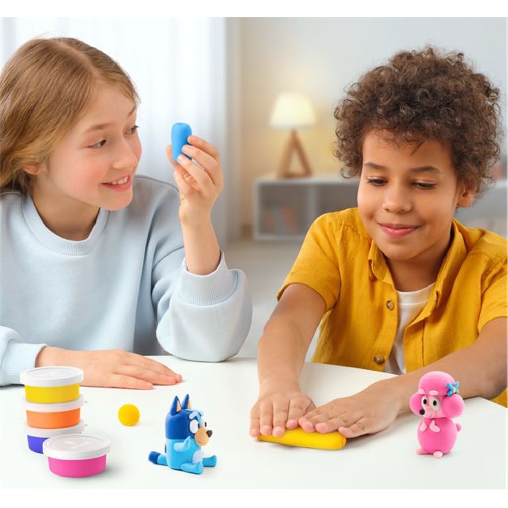 Two children playing with colorful toys on a table.