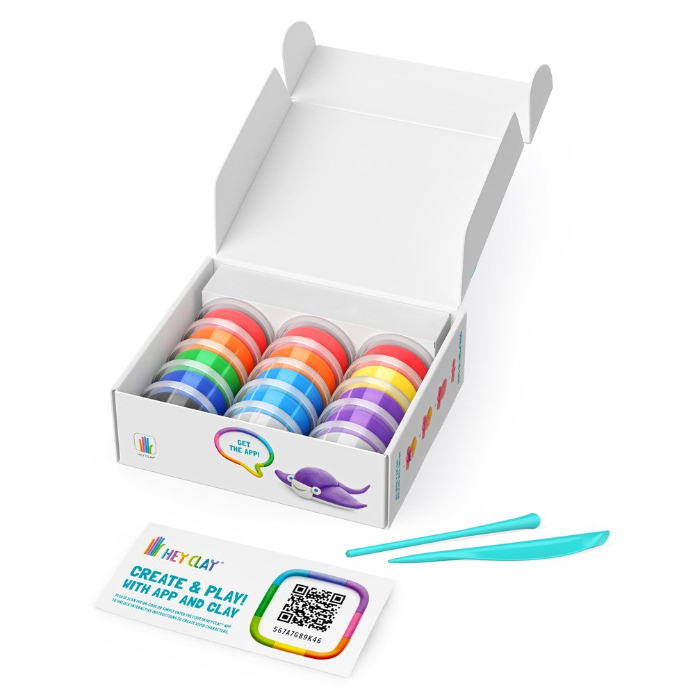 Box of colorful clay rolls with a pair of blue tools on a white background