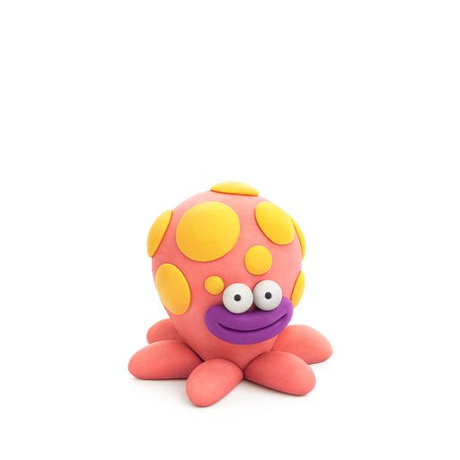 Toy figure of a pink character with yellow polka dots and a purple mouth on a white background