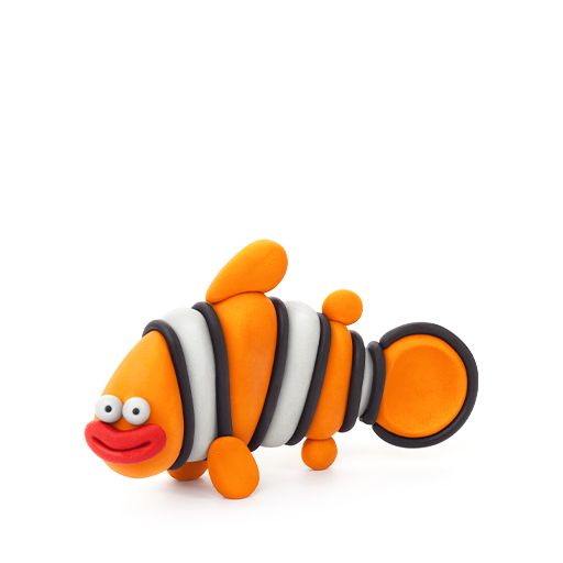 Toy fish with orange, black, and white colors on a white background