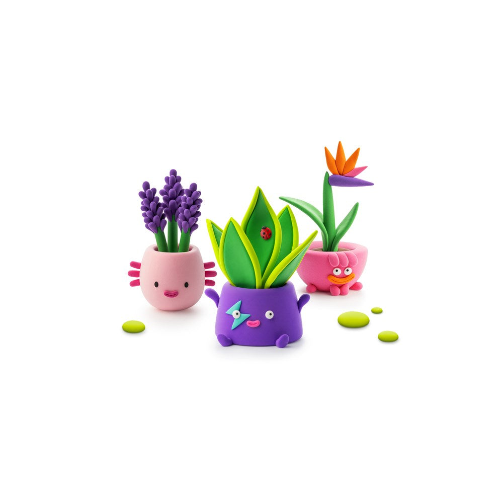 Three cute, cartoonish potted plants in pink, purple, and green, arranged on a clean white background.