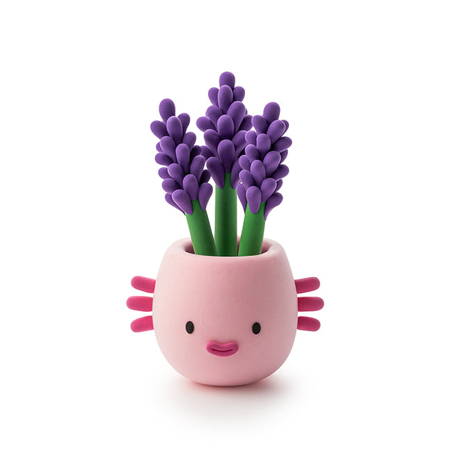 Pink axolotl-shaped planter with purple flowers on a white background