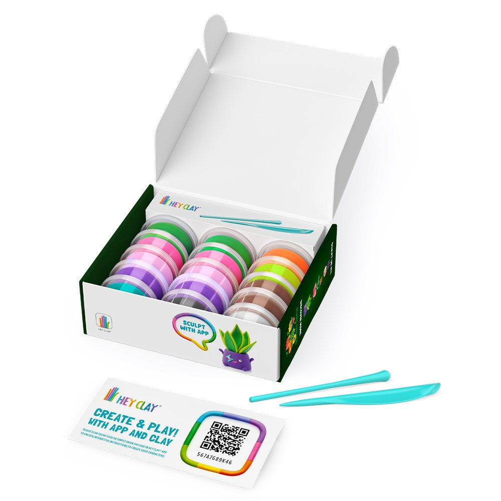 Box of colorful clay with a pair of blue tools on a white background