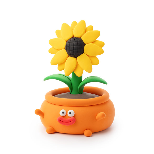 Toy sunflower with a smiling face in an orange pot on a white background