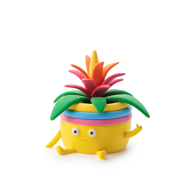 Colorful toy pineapple with a smiling face on a white background