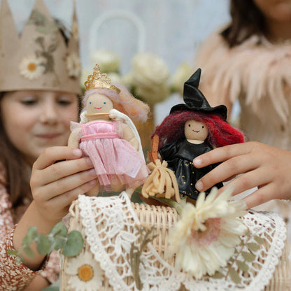 Children playing with dolls in a decorative setting
