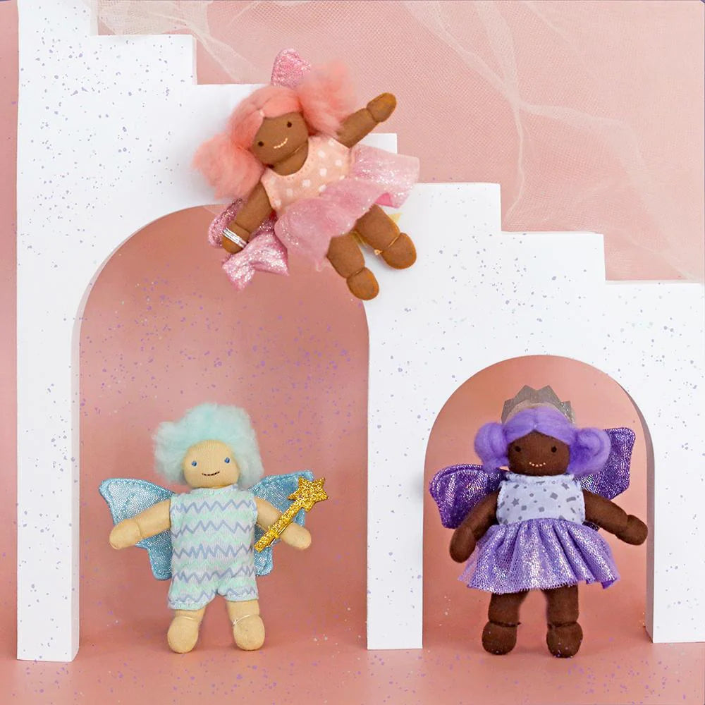 Three fairy dolls with different hairstyles and outfits on a pink background