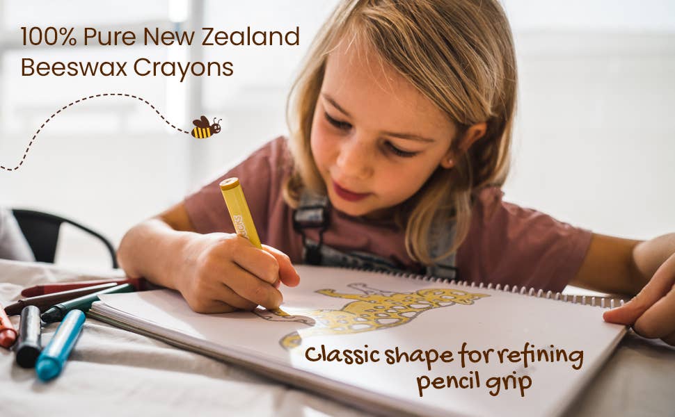 Child drawing with crayons in a notebook.