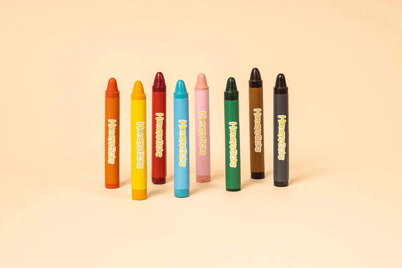 Set of colorful markers with visible brand name on a beige background