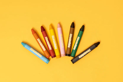 Set of colorful crayons on a yellow background