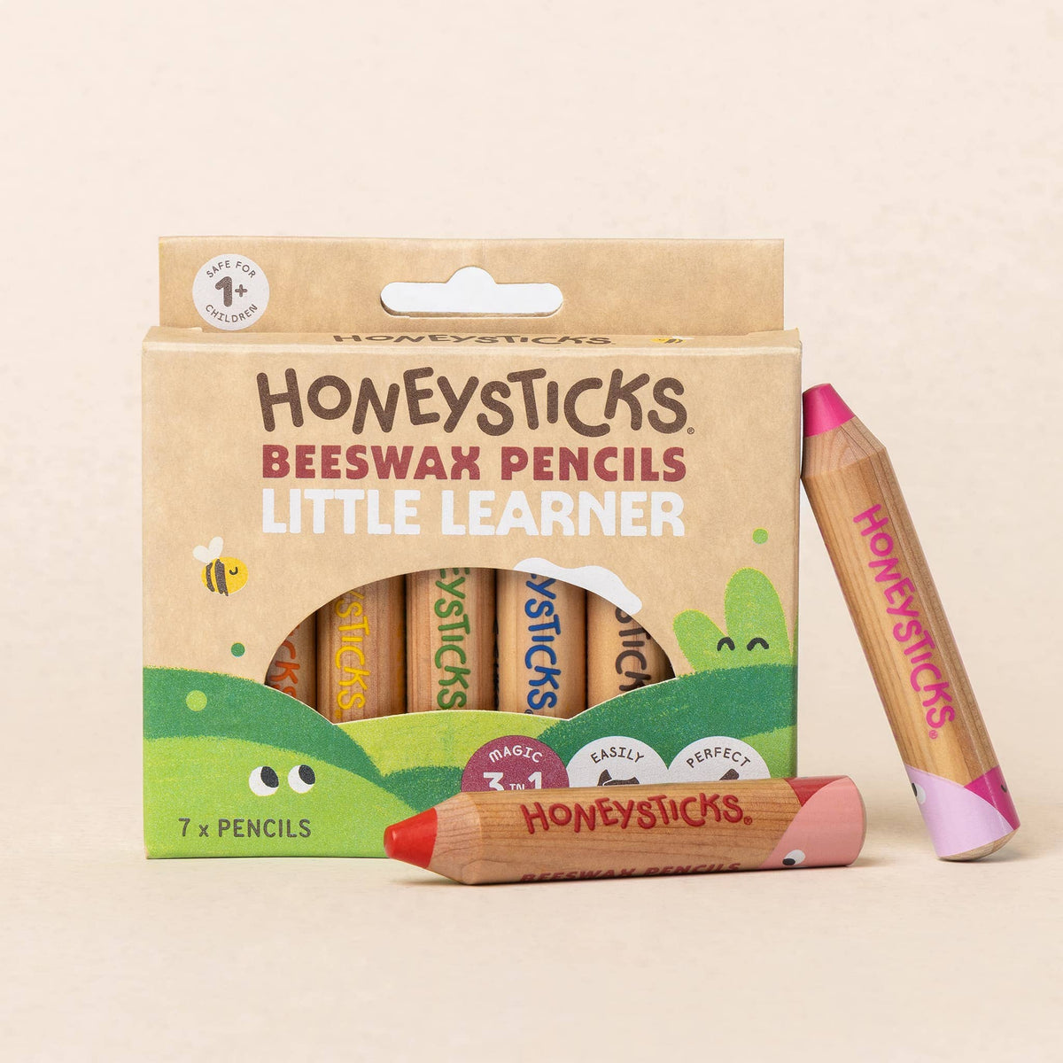 Honeysticks Beeswax Pencils packaging with a pencil displayed on a beige background
