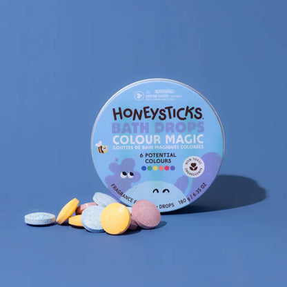 Honeysticks Bath Drops Colour Magic packaging with bath bombs on a blue background