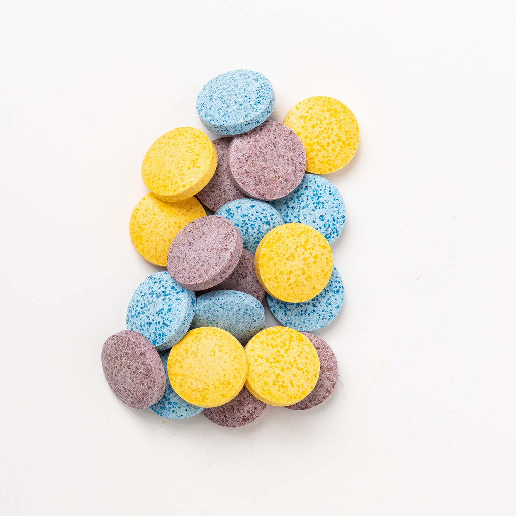 Colorful round tablets on a white background