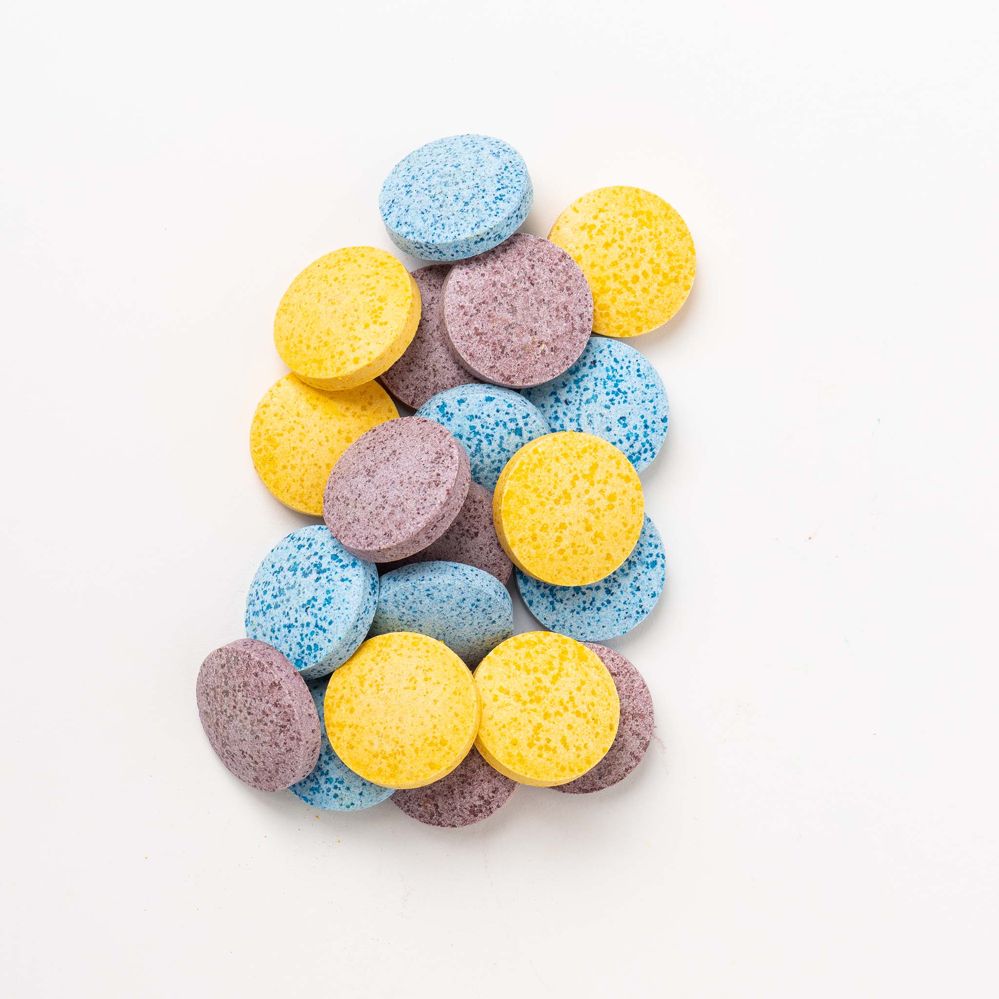 Colorful round tablets on a white background