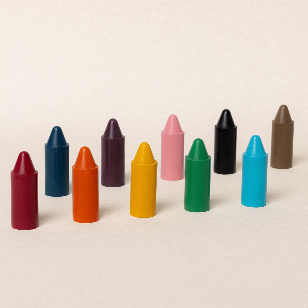 Assorted colored crayons on a beige background