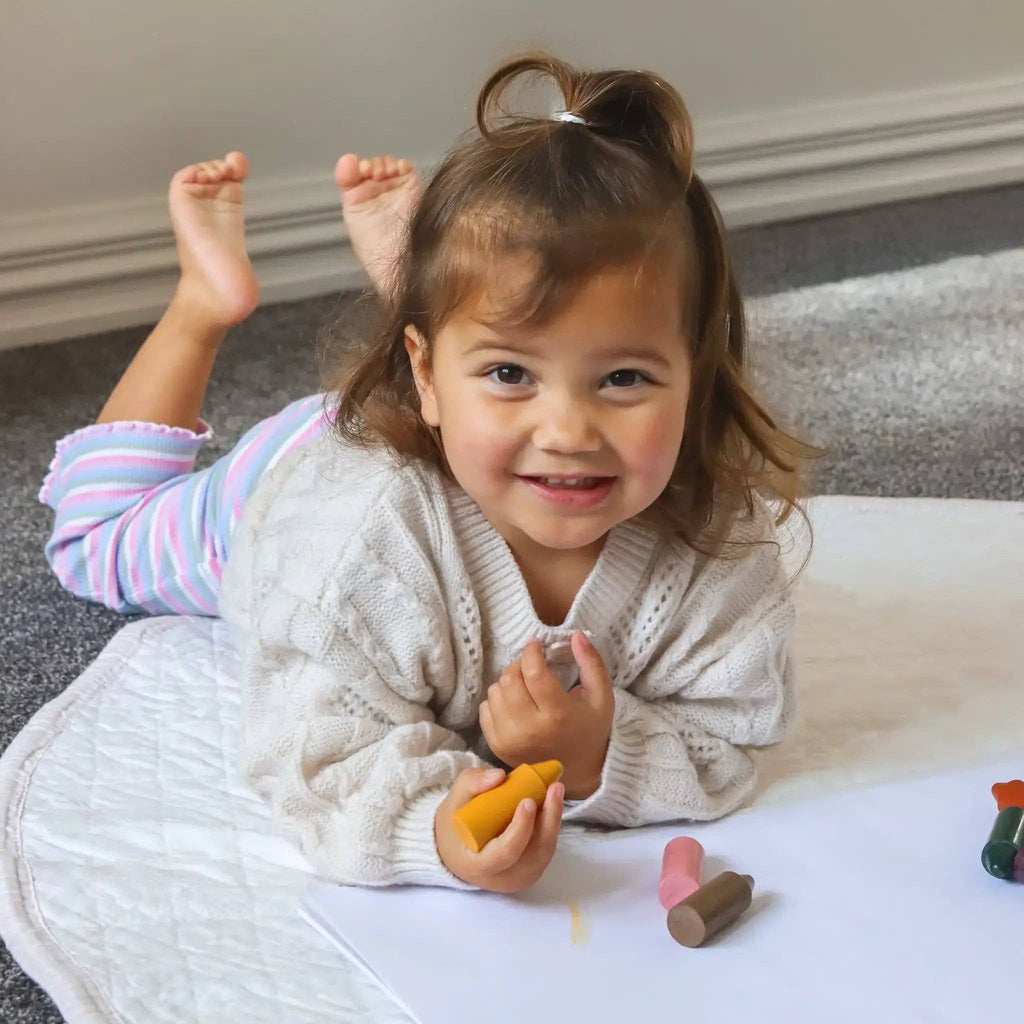 Child playing with toys on a carpeted floor