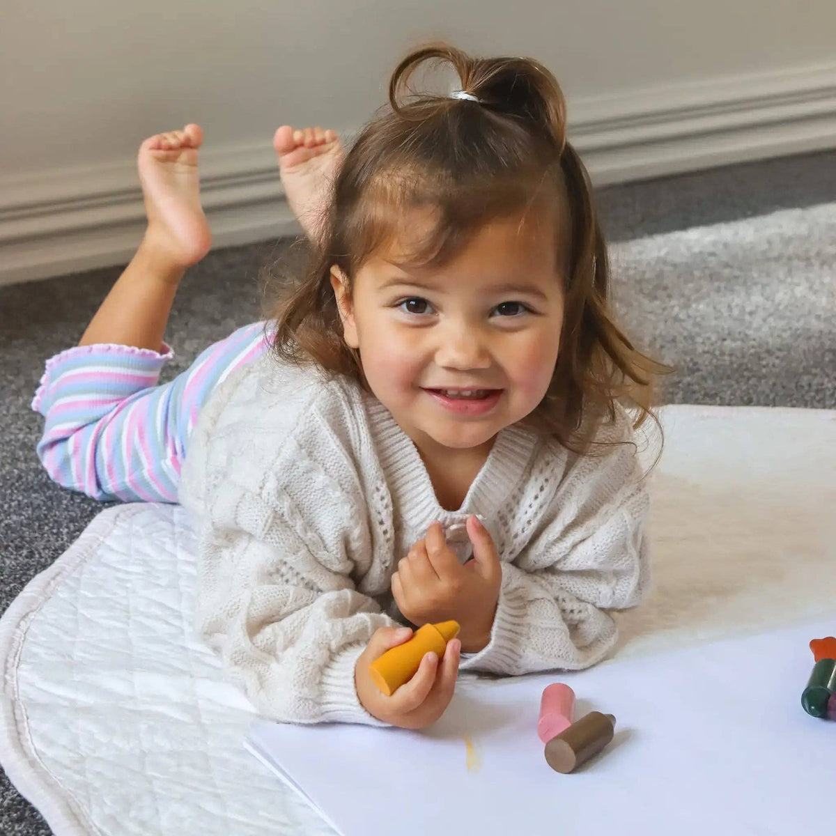 Child playing with toys on a carpeted floor