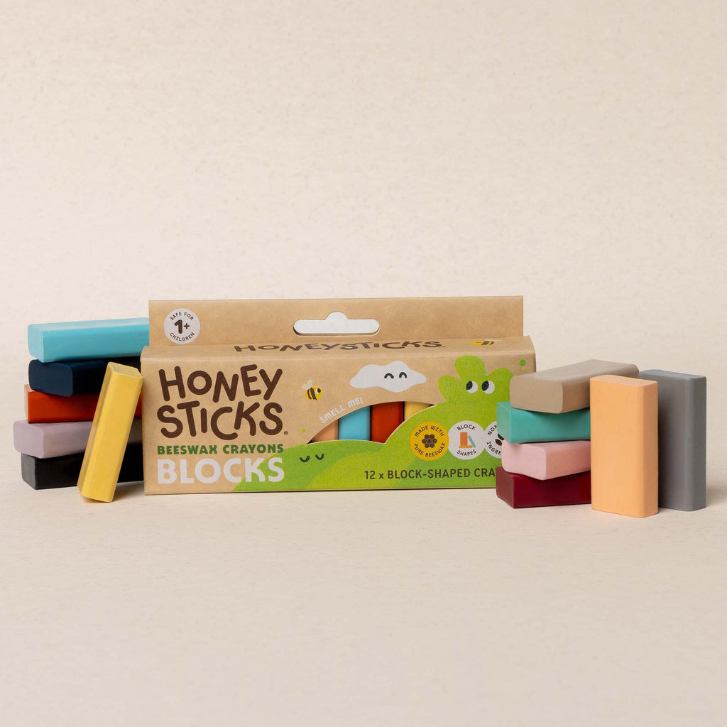 Honey Sticks crayon blocks with packaging on a beige background