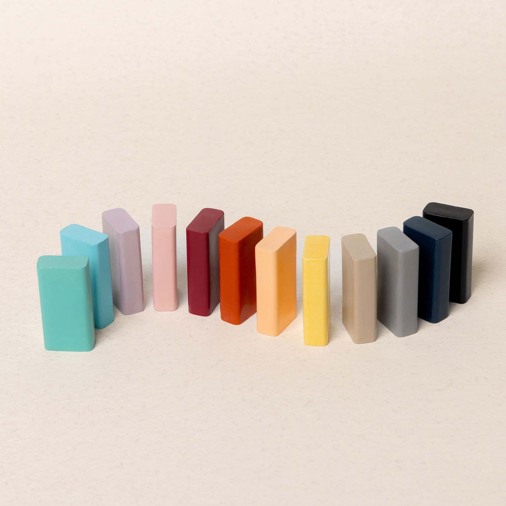Colorful crayons arranged in a row on a beige background
