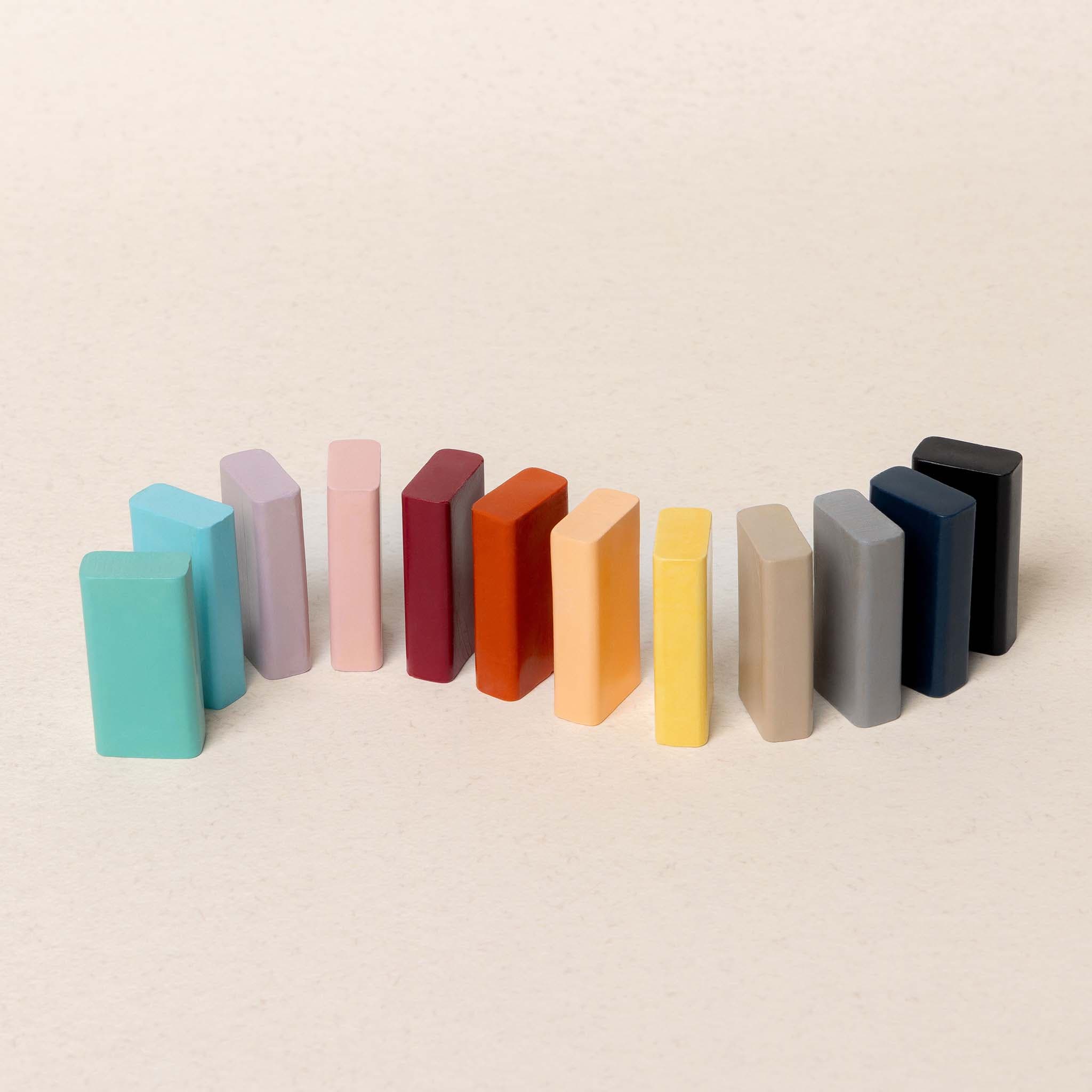 Colorful crayons arranged in a row on a beige background