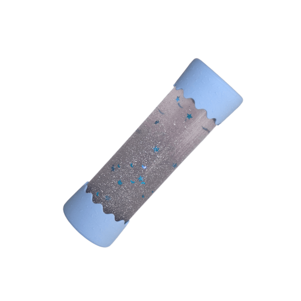 A Baby Calm Down Bottle with a transparent body and silver lid, pre-filled with sparkles and water, shown in packaging with a geometric pattern.