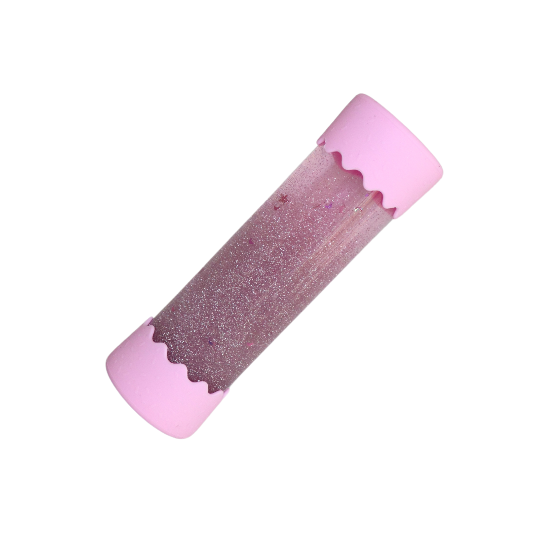 A Baby Calm Down Bottle with a transparent body and silver lid, pre-filled with sparkles and water, shown in packaging with a geometric pattern.