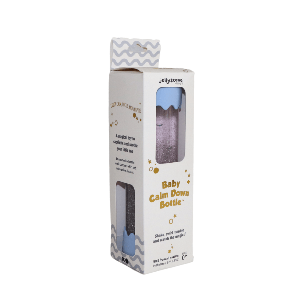 A Baby Calm Down Bottle with a transparent body and silver lid, pre-filled with sparkles and water, shown in packaging with a geometric pattern.