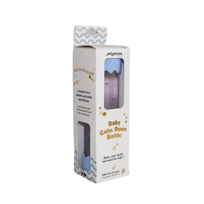 A Baby Calm Down Bottle with a transparent body and silver lid, pre-filled with sparkles and water, shown in packaging with a geometric pattern.