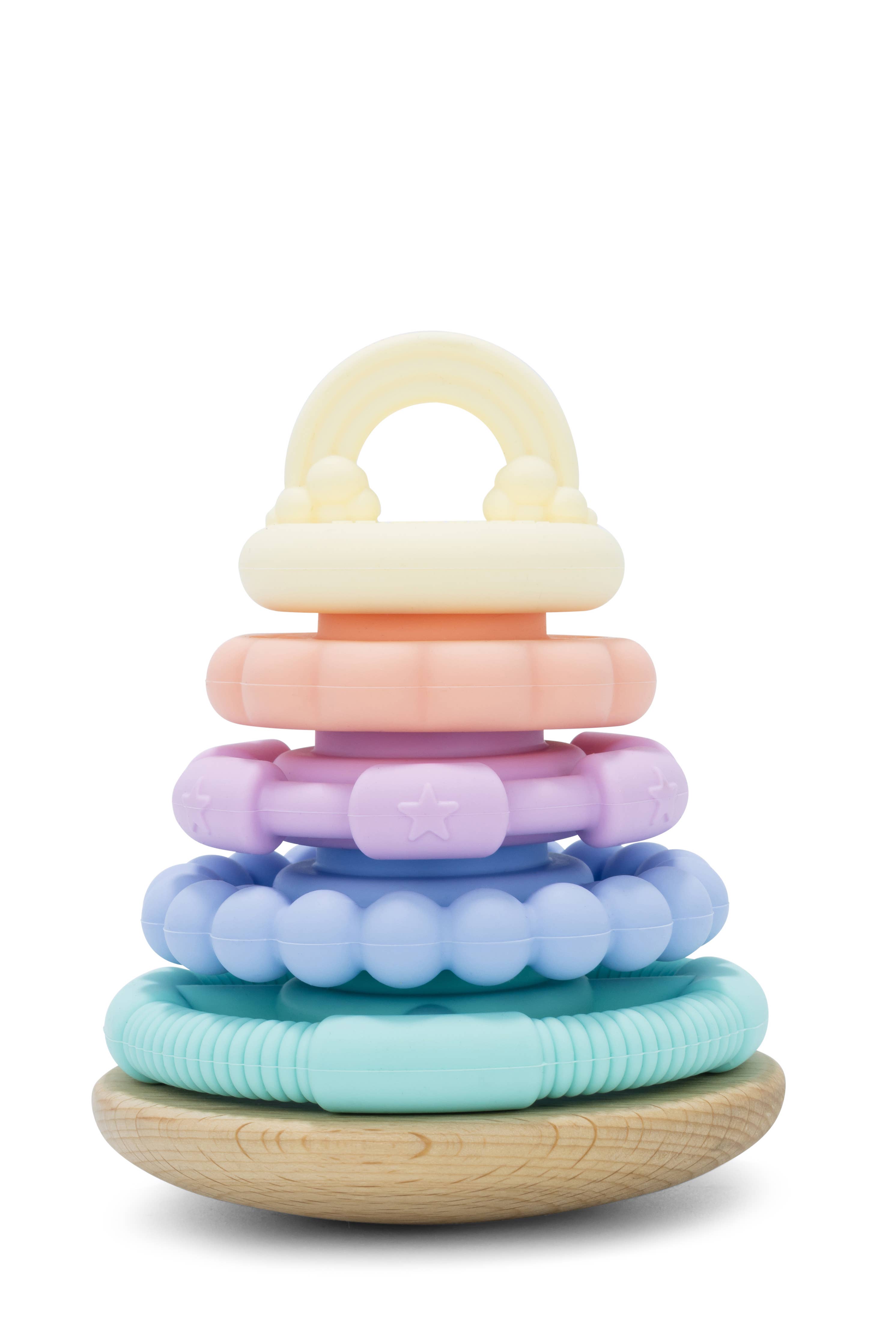 A colorful stacking toy made of beech wood with a series of round rings in pastel colors, stacked on top of each other with a wooden base.