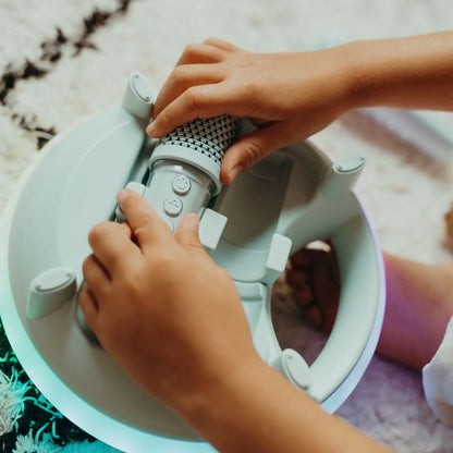 Person assembling a white electronic device with a textured gray component.