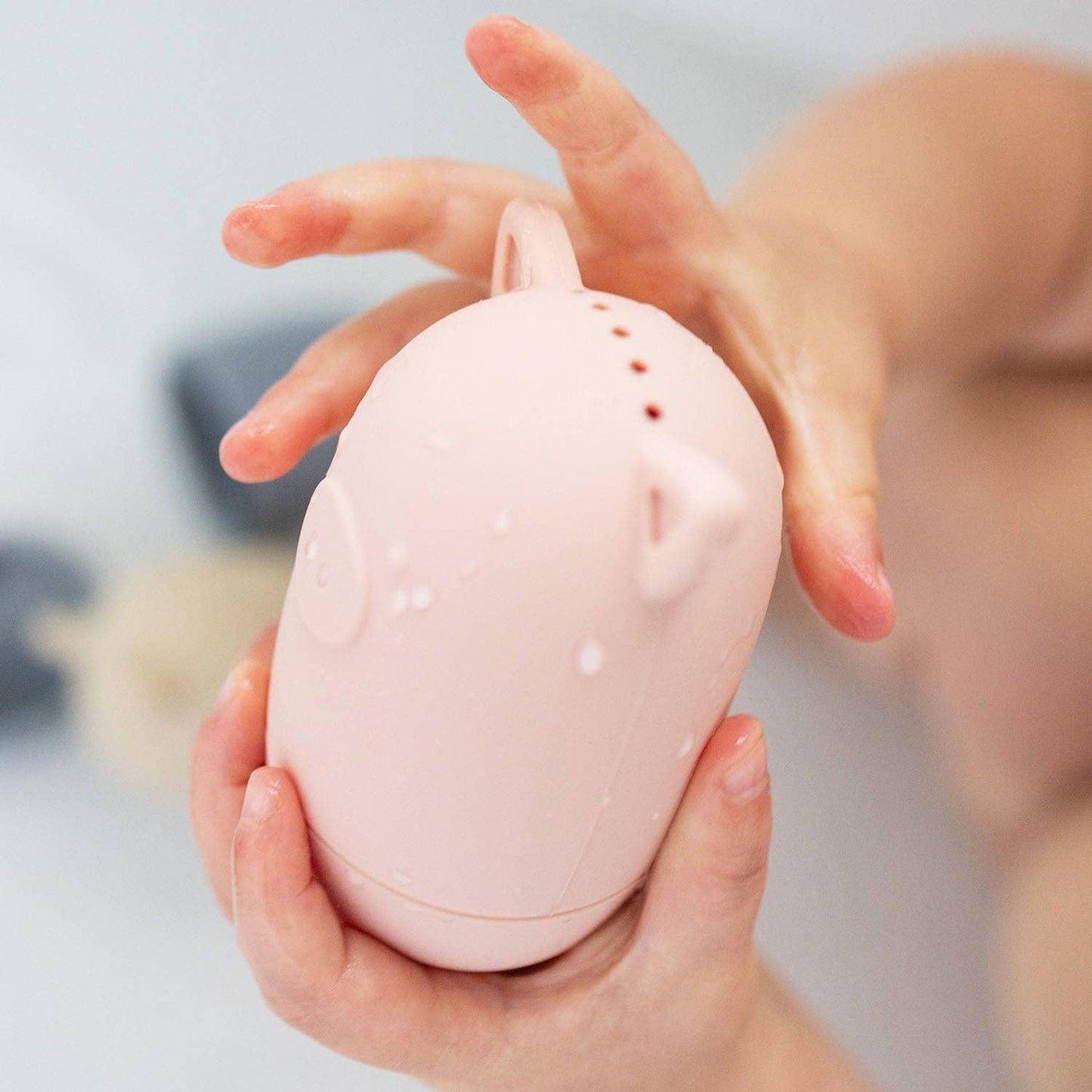 A silicone bath toy shaped like an animal face.