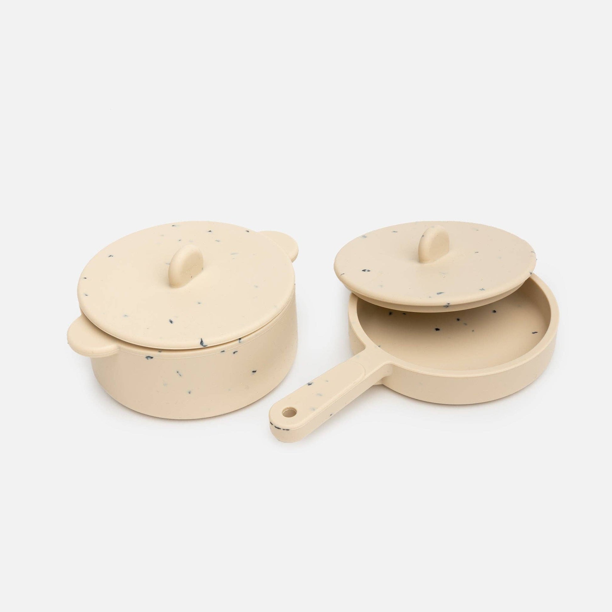 Beige silicone toy pot and pan with lids on white background.