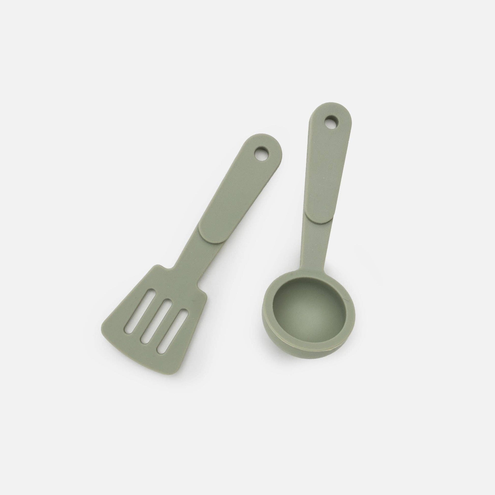 Green silicone utensils on white background. 