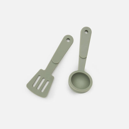 Green silicone utensils on white background. 