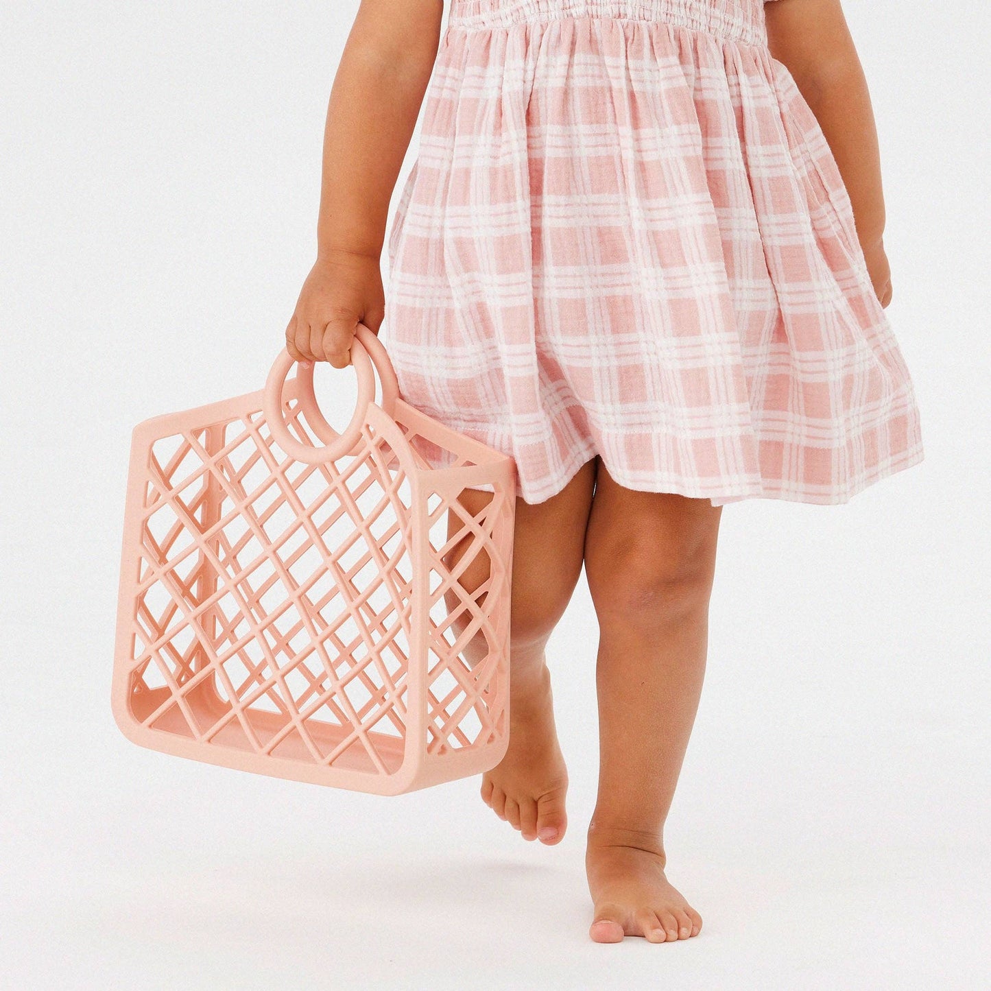 Child holding Kynd Baby - Silicone Bag - Pink Clay
