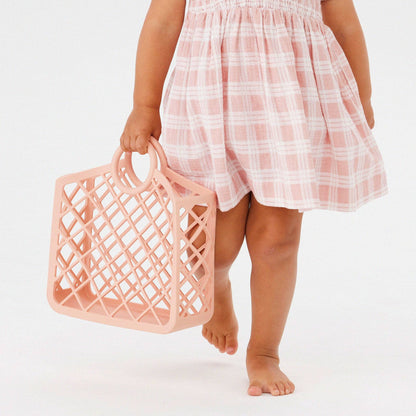 Child holding Kynd Baby - Silicone Bag - Pink Clay