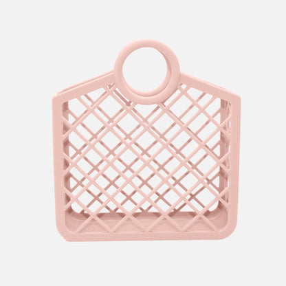 A pink silicone bag with a geometric grid pattern and a loop on top for hanging.